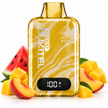 A yellow marbled disposable vape device with a digital screen showing 100% battery, surrounded by fresh fruit slices including watermelon, peach, and mango on a white background. The brand name 'DUKITLEL' is visible on the front of the device.
