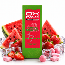 A green and red box of OX Passion Freeze watermelon bubble gum stands upright on a white surface, surrounded by watermelon slices, strawberries, ice cubes, and pink gum pieces. The box label reads 'OX PASSION' and 'POWERED BY CHVA' with 'Freeze' and 'Watermelon' visible.